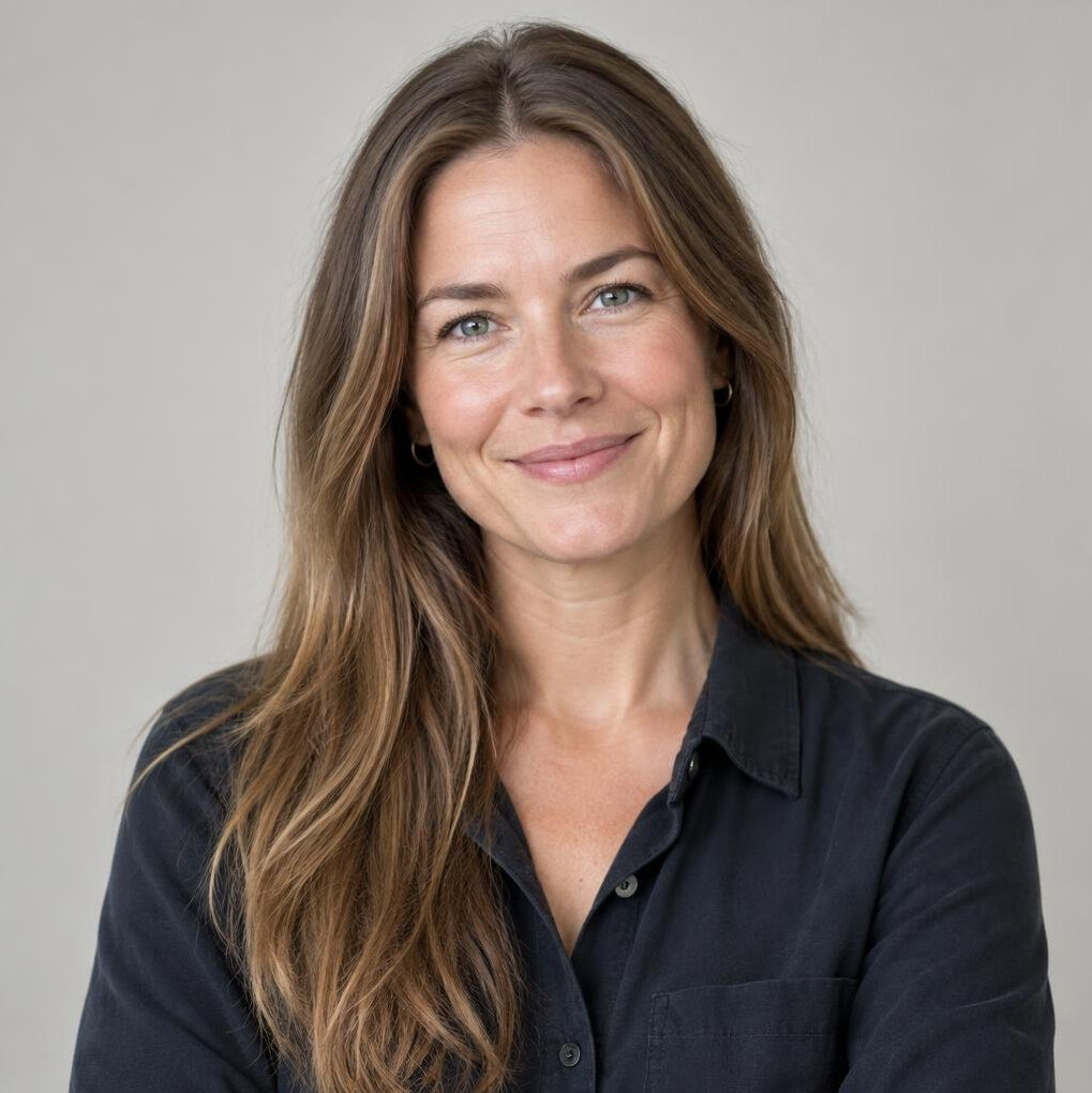 Woman with long hair smiling in a studio portrait