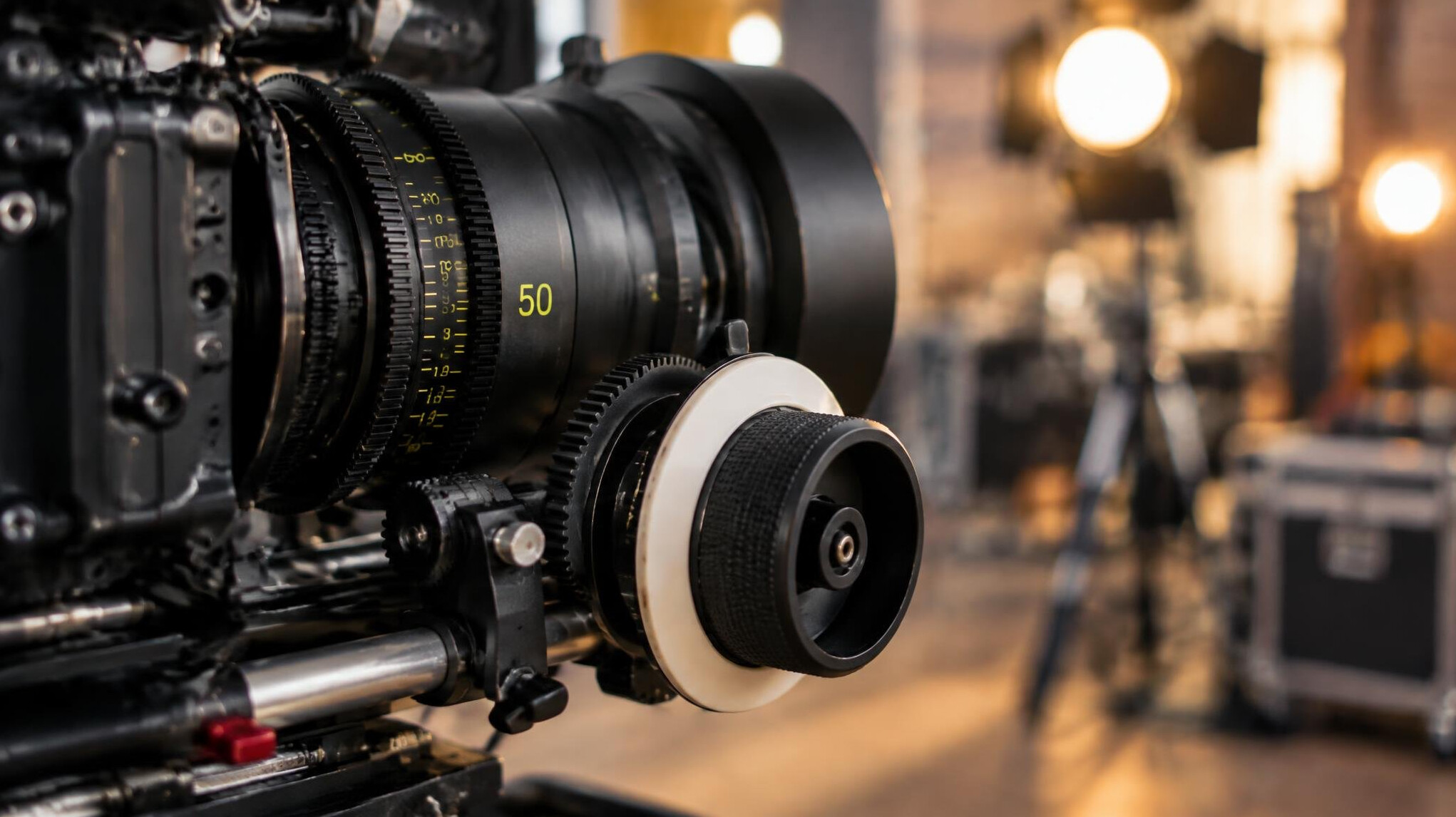 Close-up of a professional camera lens on a production set