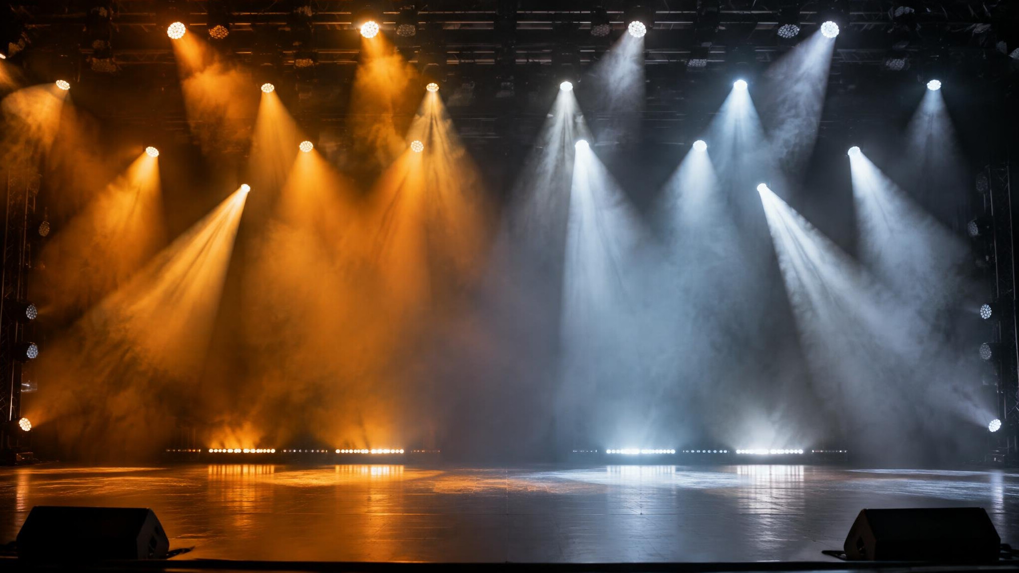 Stage lights changing colour above a concert stage